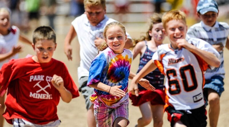 Happy Canadian children playing outdoors, representing family and Canada Child Benefit support.