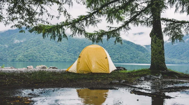 camping in the rain - tent pitched during a downpour with rain gear nearby