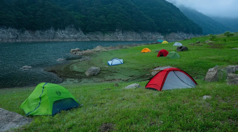 camping in Newfoundland and Labrador - iceberg drifting past a coastal campsite