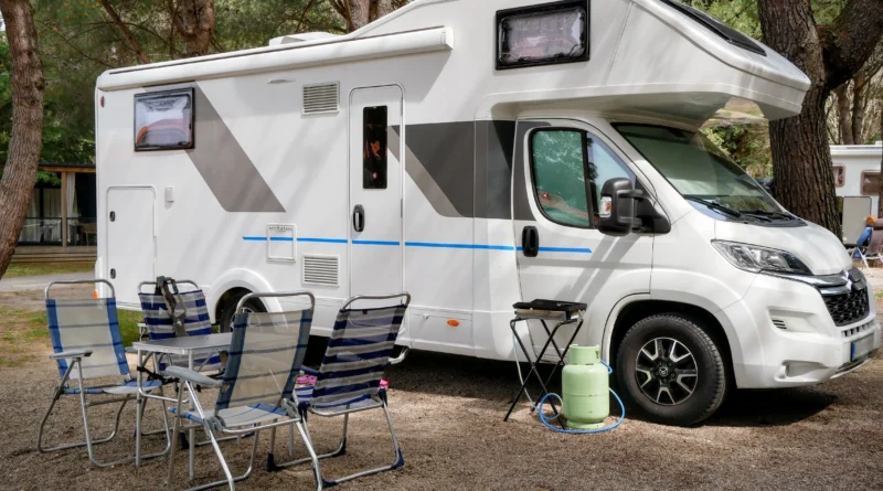 RV vs tent camping Canada - travel trailer parked beside a pitched tent
